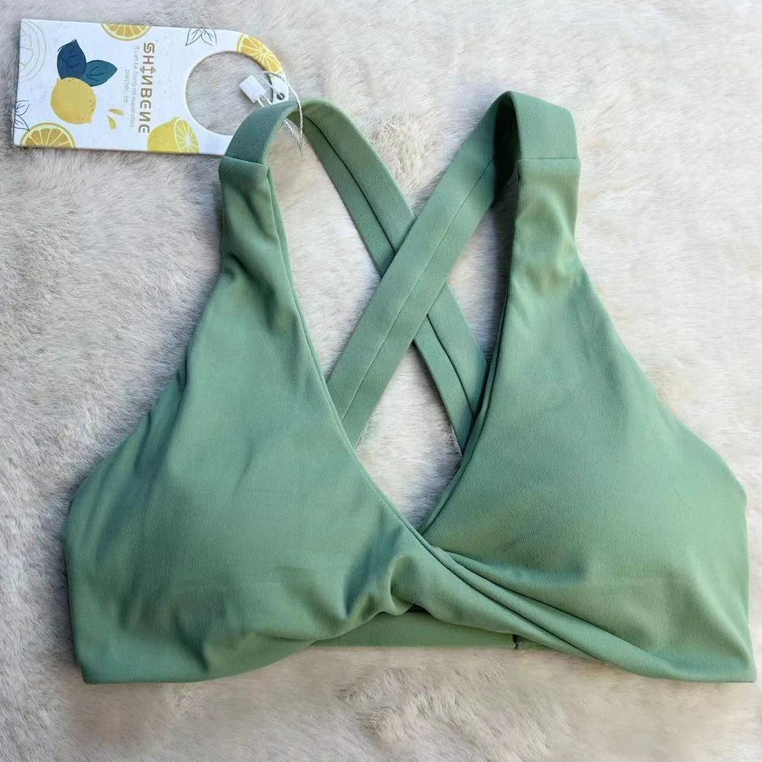 Strappy cross back padded nylon spandex knit yoga bra with twist front design - product image